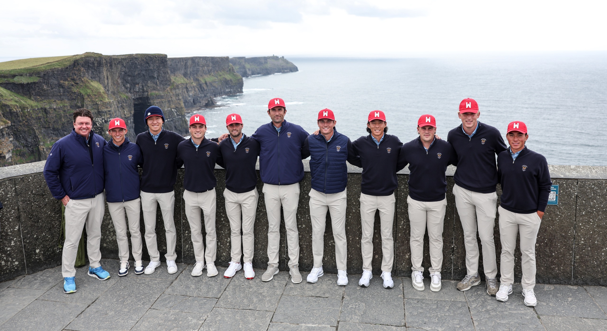 Walker Cup Team USA 2026 pose for a group photo in front of the sea