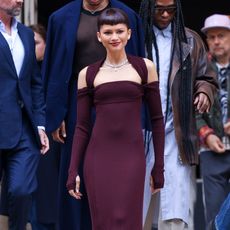 Zendaya attending the Fendi Couture Show in a purple ribbed gown with shoulder cutouts 
