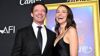 Hugh Jackman and Sutton Foster standing together and smiling at the AFI Fest 2025 Closing Night Premiere of "Song Sung Blue" held at the TCL Chinese Theatre on October 26, 2025 in Los Angeles, California.