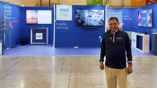 Ravindra (Ravi) Velhal stands in the company&#039;s booth at the International Broadcasting Center in Olympic Games Village