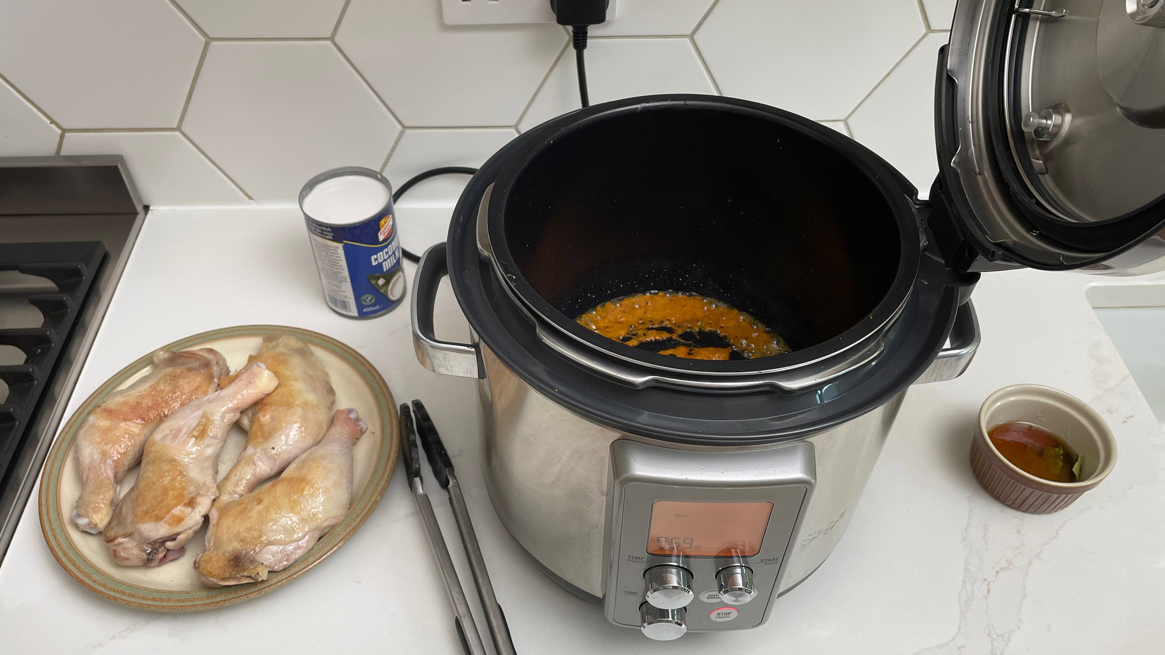 Breville the Fast Slow Pro on a kitchen countertop being used to cook a curry