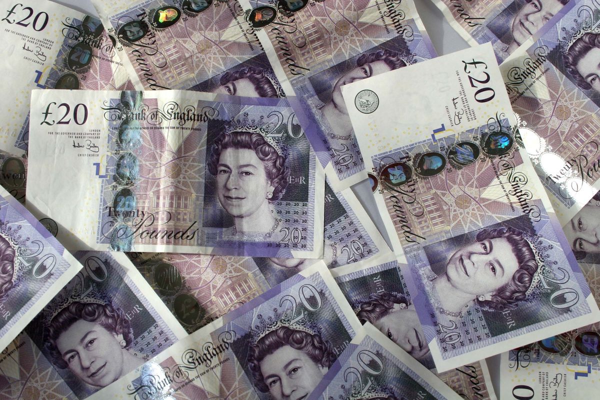 £20 banknotes spread unevenly over a surface.