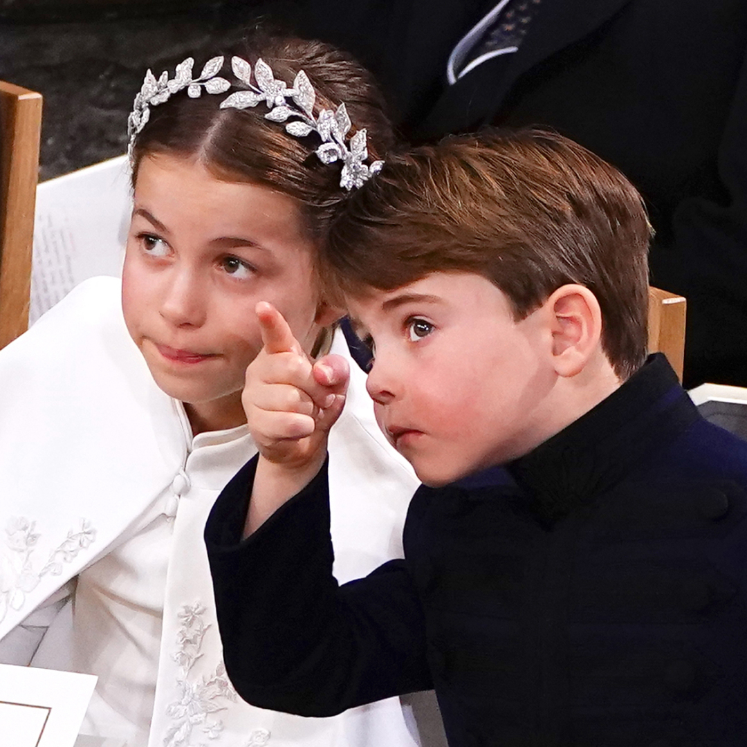 Princess Charlotte wears a white cape and has a leafy silver crown, while Prince Louis wears a navy coat and points