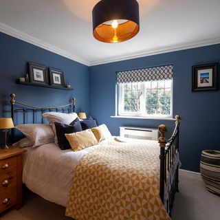 Blue bedroom with double bed and side table