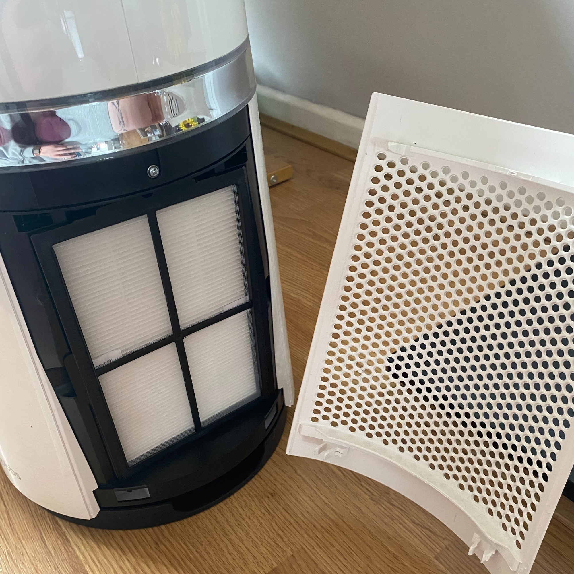 Open filter panel on the Russell Hobbs RHBLDL25 Bladeless Fan Heater on a wood effect floor