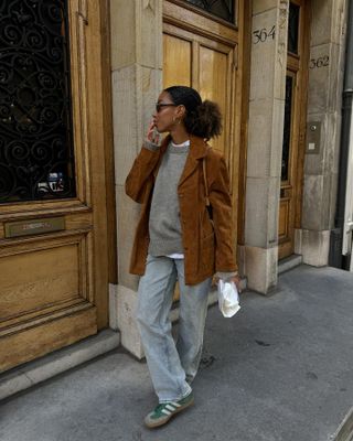 Amaka Hamelijnck in a brown suede jacket