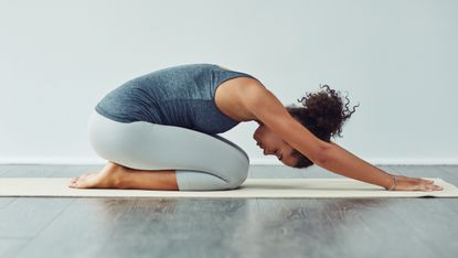 woman doing yoga childs pose for bedtime yoga