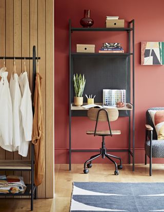 orange home office in living room open plan desk with shelving and stool