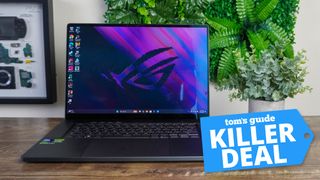 The Asus ROG Zephyrus G16 (2024) pictured sitting on a desk with the &quot;Tom&#039;s Guide Killer Deal&quot; badge