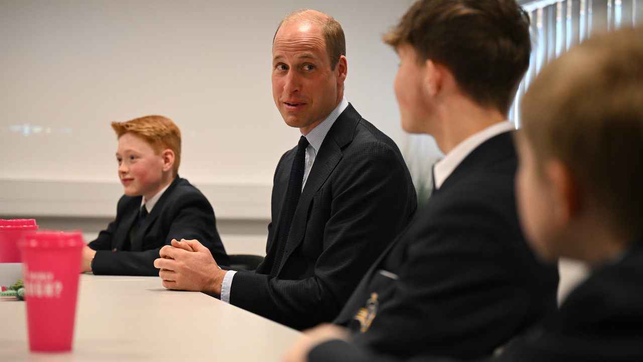 Britain&#039;s Prince William, Prince of Wales (C) speaks with students of the Matrix Project, including twelve-year-old Freddie Hadley (L), who made the initial invitation to visit the school