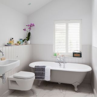 bathroom with white wall and white bathtub