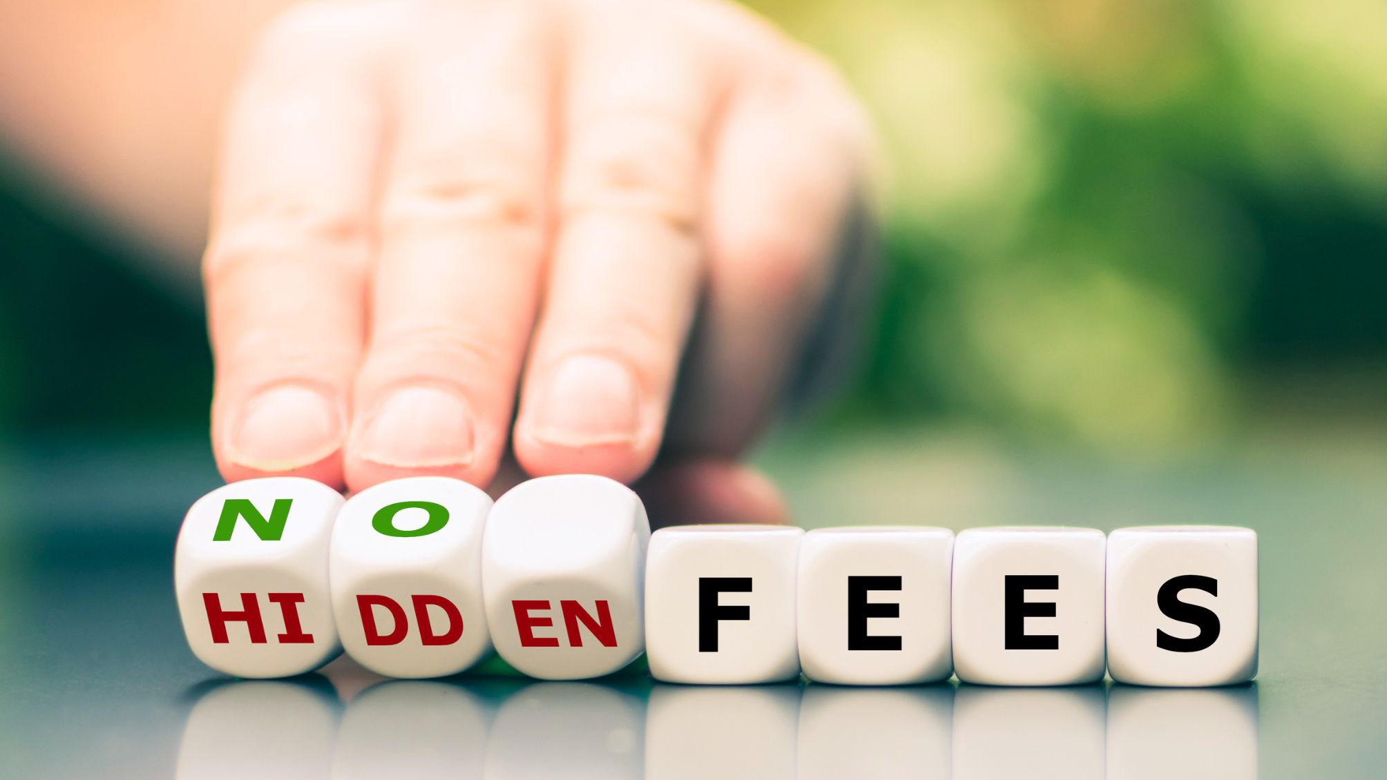 No hidden fees concept. Hand turns dice and changes the expression "hidden fees" to "no fees".