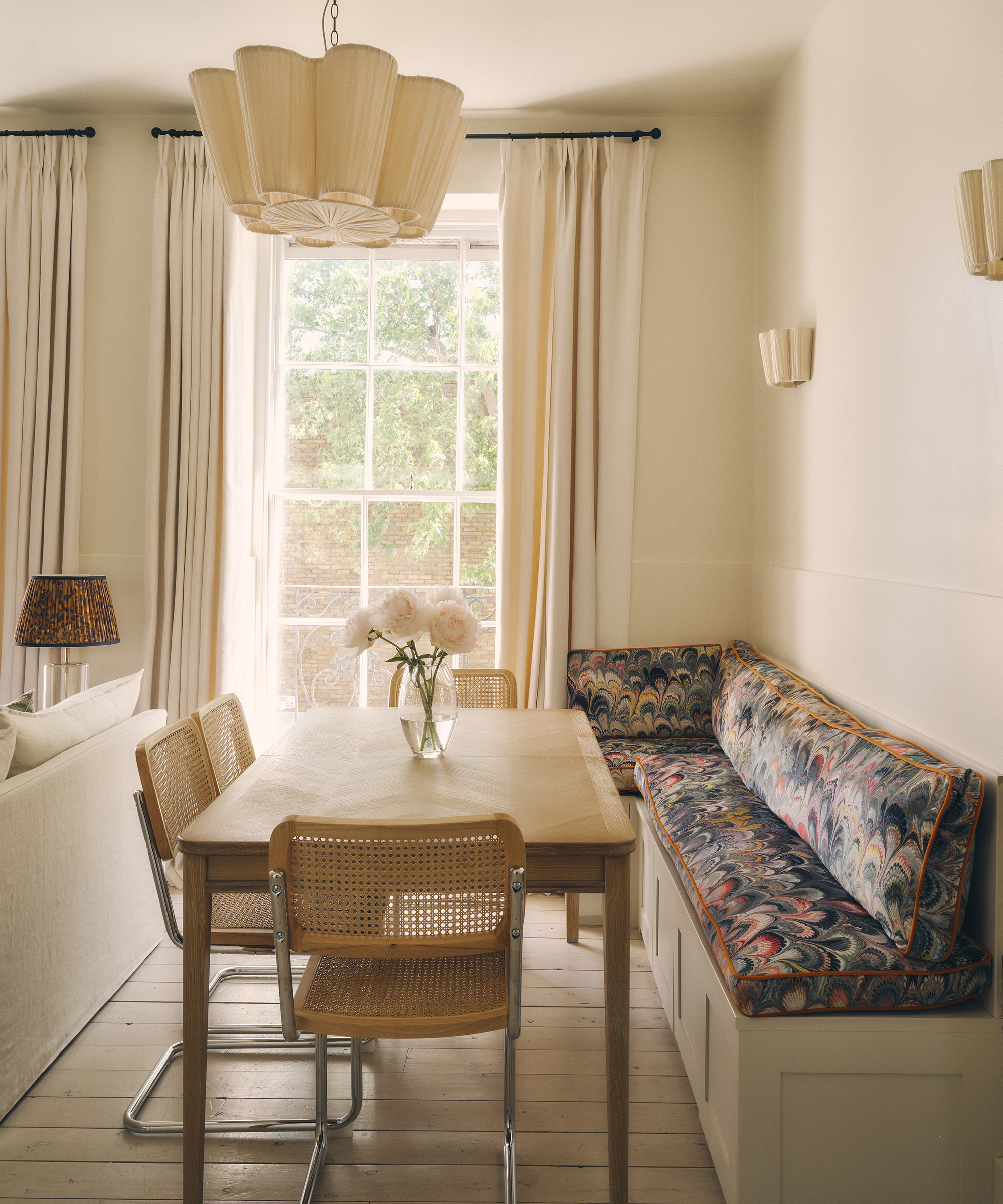 dining table with wood chairs and patterned banquette