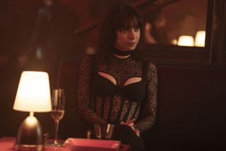 A photo of Sofia Falcone from The Penguin wearing a black lace corset dress