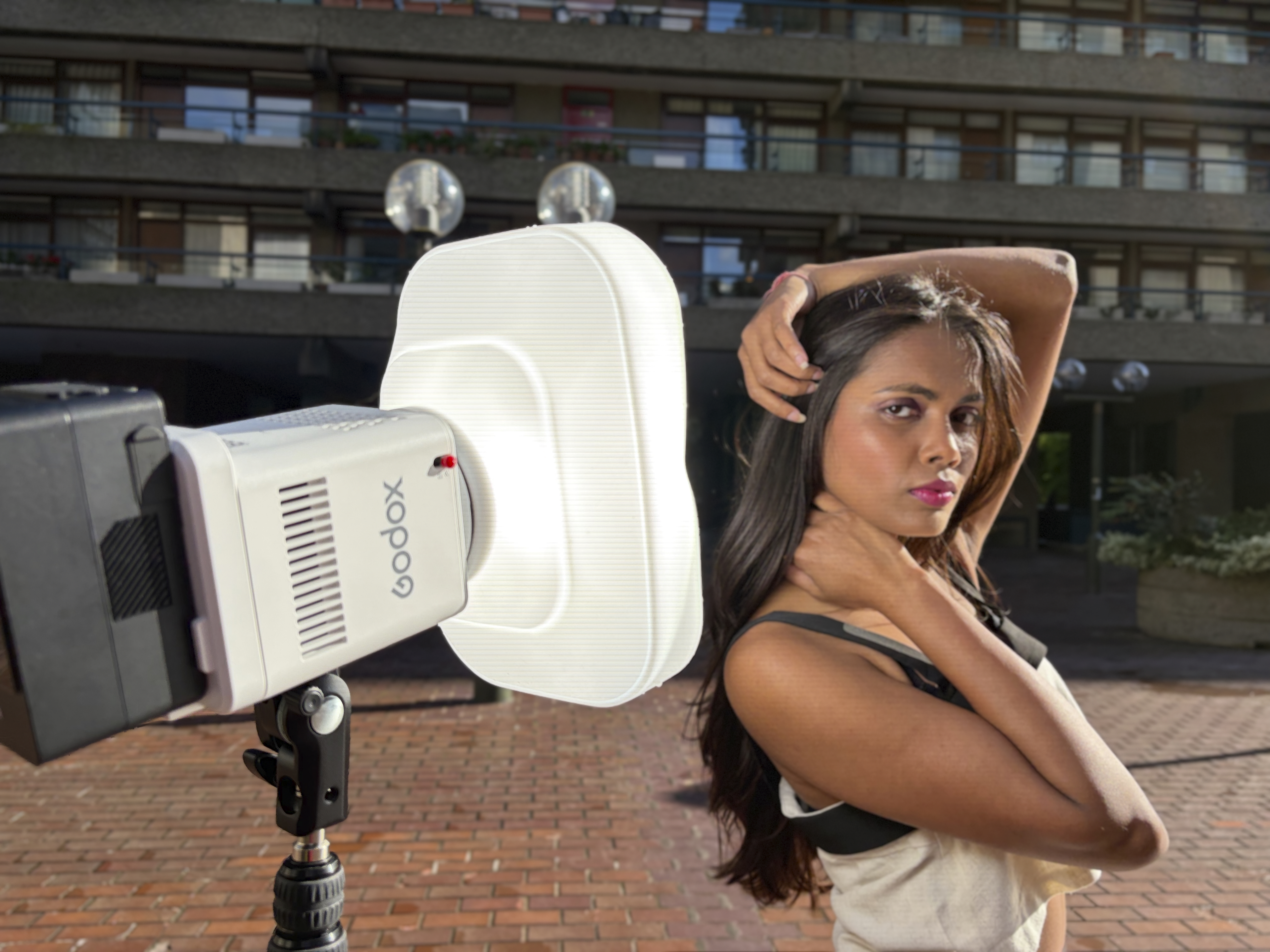 Shot of the ML150Bi mounted on a lighting stand with a soft box attached to the front. This fills in harsh shadows on the model with a flattering soft light.