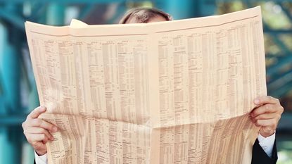 Man reading a financial newspaper