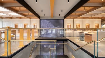 Vashi jewellery store with large screen surrounded by neutral tones and touches of gold