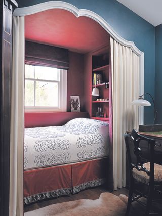 boho bedroom ideas with a red alcove bed in a blue room