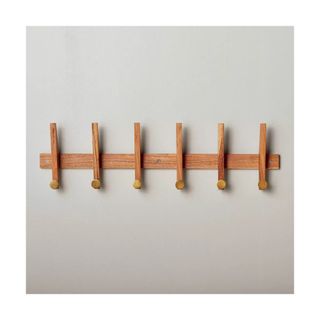 Modern wooden peg rail with brass details