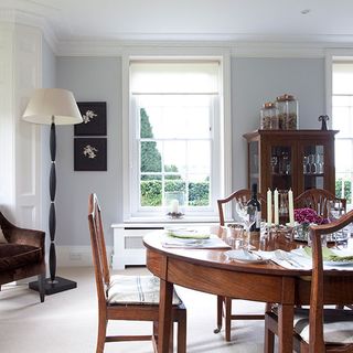 dining area with white wall and dining table with chairs