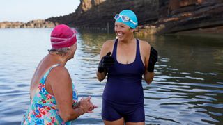 Two women in their 50s swimming together