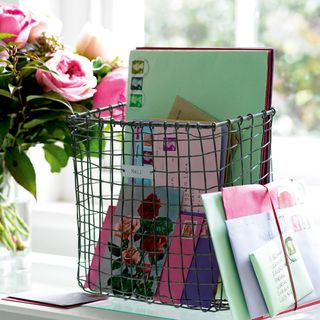 mail basket with colourful letters and flower vase