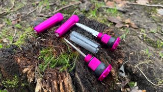 Muc-Off Stealth Tubeless Puncture Plug parts on a log