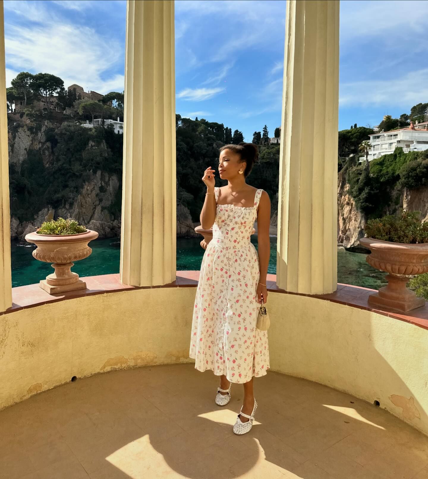 Woman wearing a white floral-print dress in Spain