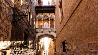 A close up of a street in Barcelona's Gothic Quarter with light brown stone walls