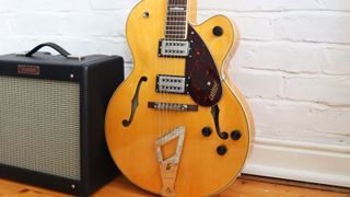 Gretsch G2420 against a white brick wall