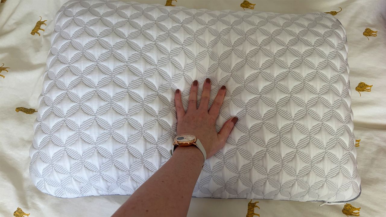 Tester Ruth Jones places her hand on the Helix Talalay Latex Pillow to test the cushioning and support