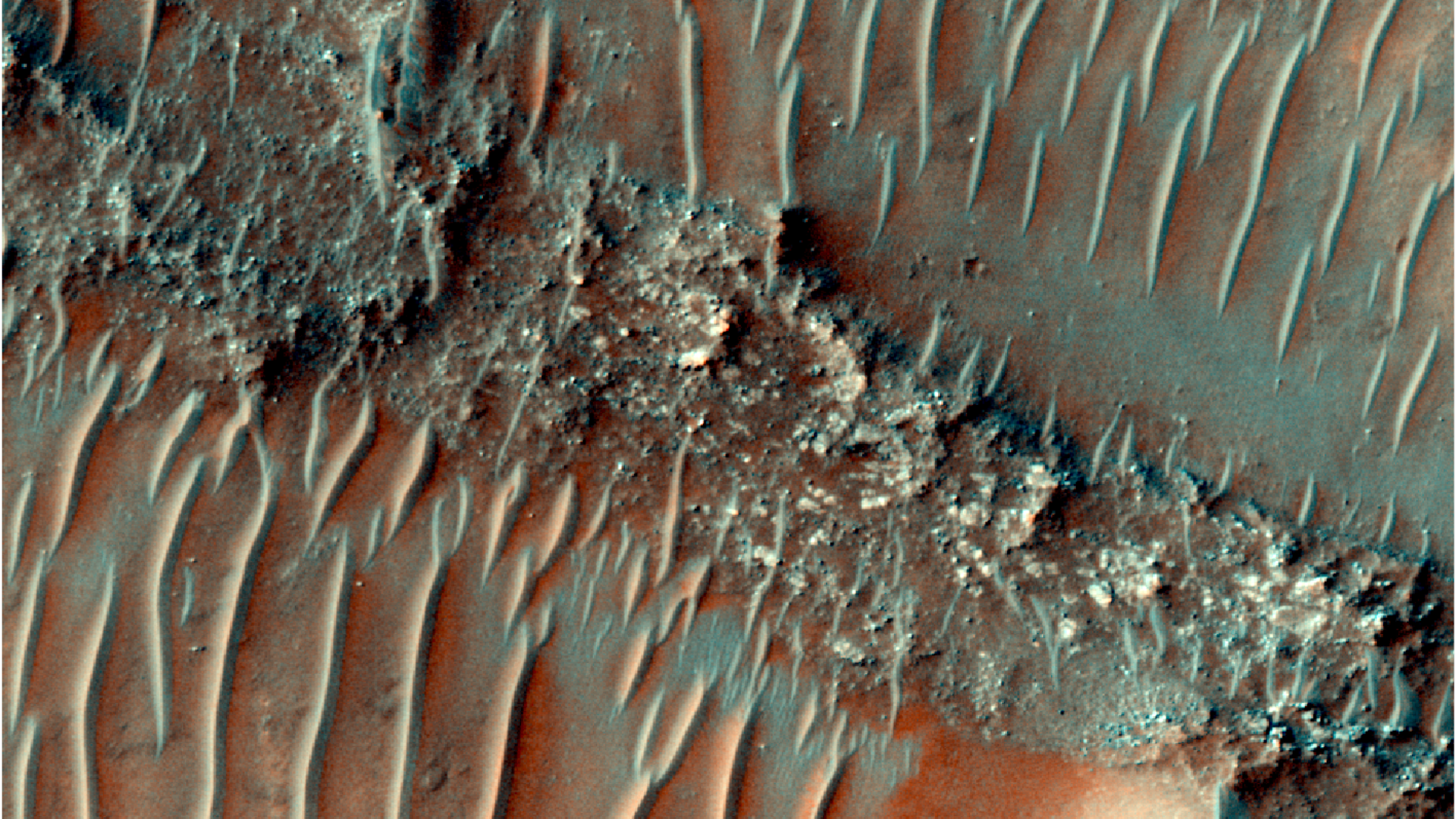 A series of dried up river beds streak across the reddish surface of Mars as seen from low orbit