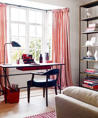 home office with striped curtains and open shelving