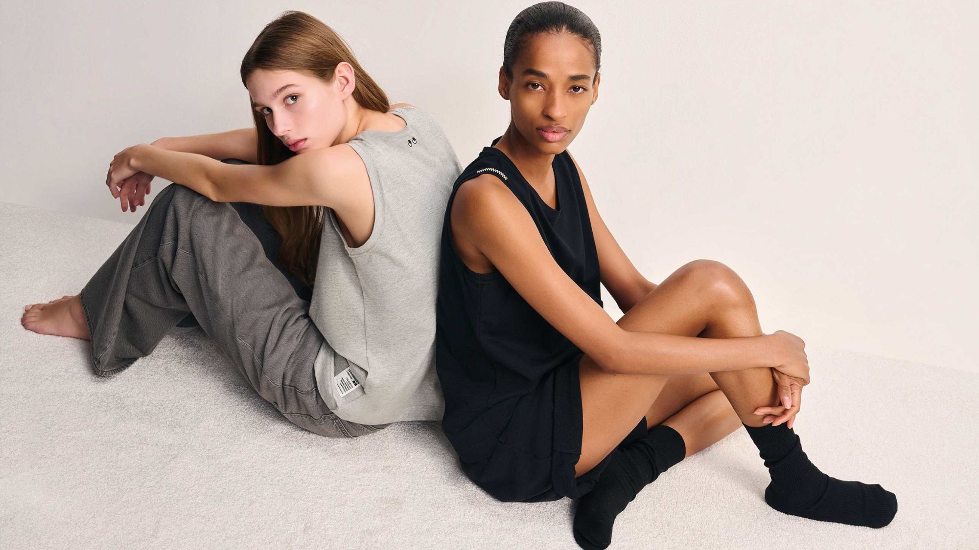 two models wearing tops from the anya hindmarch x uniqlo collaboration