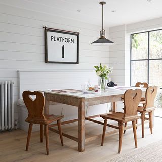 dining room with white wall and dining table