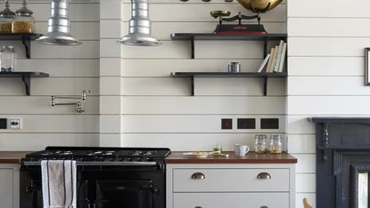 Pot filler taps trend in a white wooden kitchen