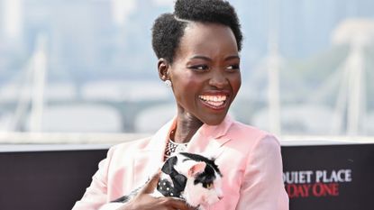 Lupita Nyong’o poses with her cat during a photocall for 'A Quiet Place: Day One'