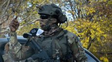 A masked ICE agent is seen in Chicago.