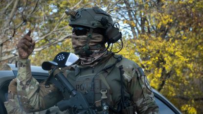 A masked ICE agent is seen in Chicago.