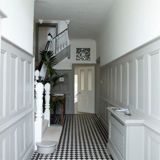 hallway with white walls and stairs