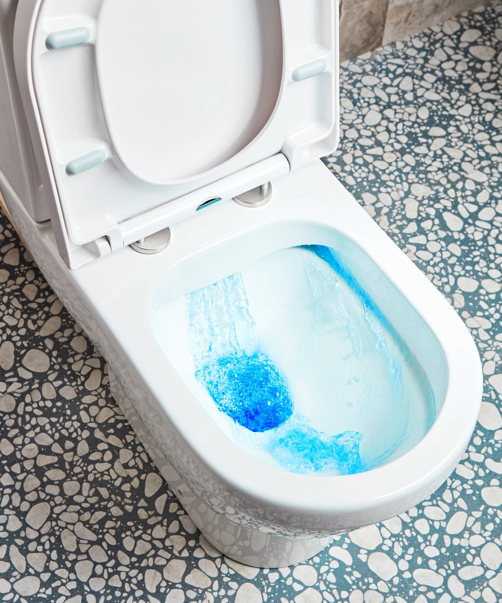Toilet flushing with blue block cleaner rinsing through