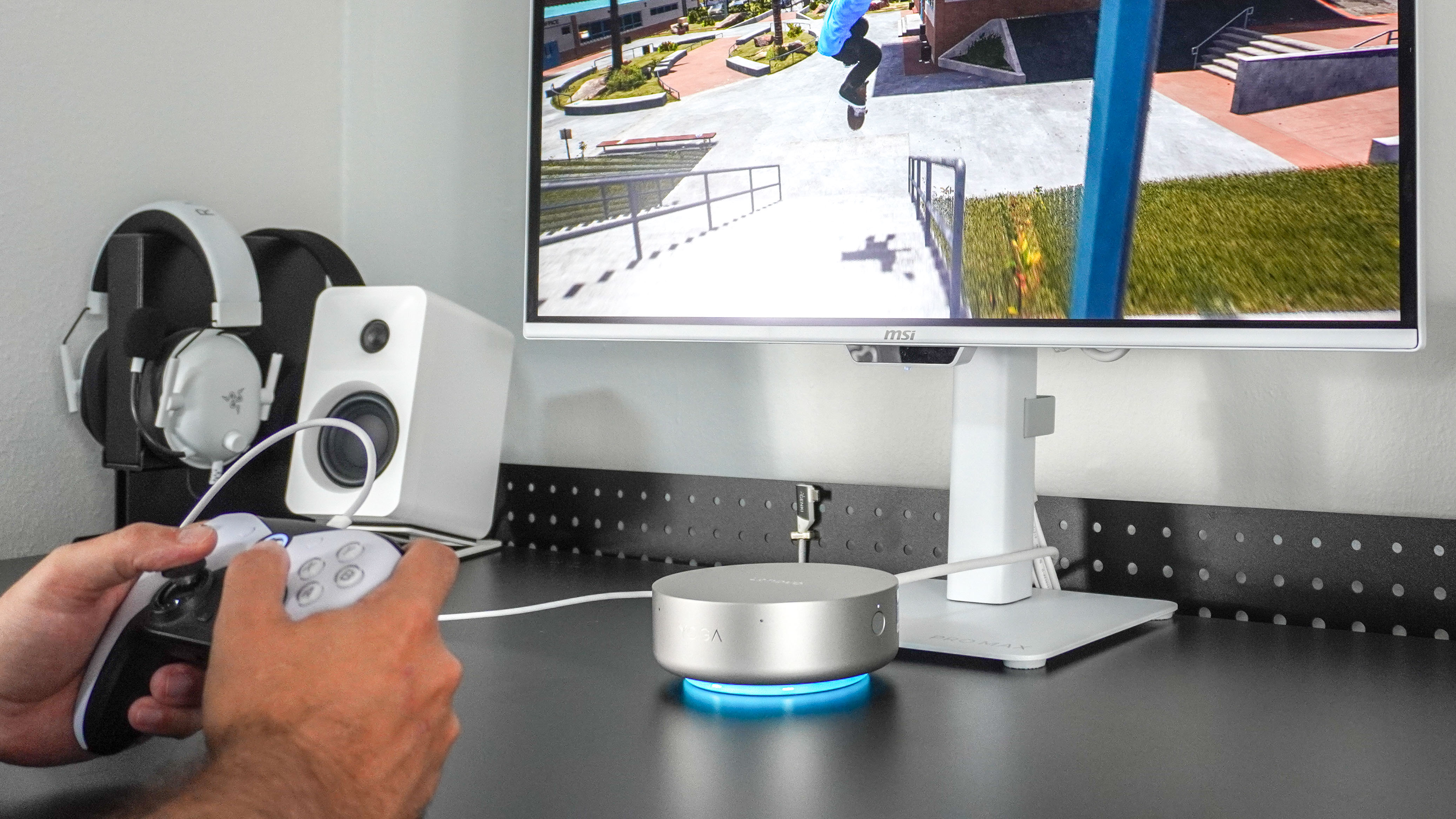 A person holding a controller and playing games on the Lenovo Yoga Mini