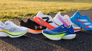 Selection of running shoes on an asphalt path with grass in the background
