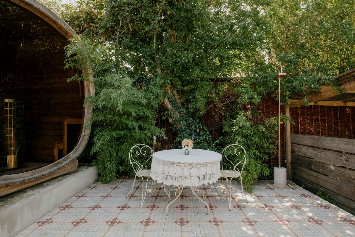 A egg chair in the garden next to the pool with tiled flooring