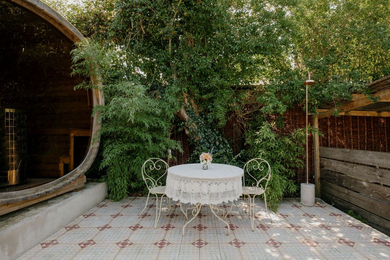 A egg chair in the garden next to the pool with tiled flooring