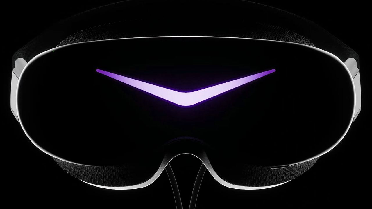The Pimax Dream Air SE VR headset shot from the front, lit up in purple