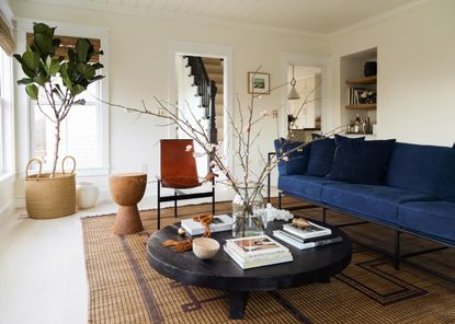 Modern rustic living room with branches in a vase