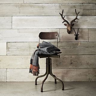 trophy heads on wooden wall and chair