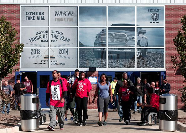 Workers leave a Chrysler Fiat plant in Michigan.