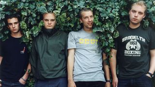 UNITED KINGDOM - JULY 01: Photo of Chris MARTIN and COLDPLAY and Jonny BUCKLAND and Will CHAMPION and Guy BERRYMAN; Posed group portrait in hedge L-R Guy Berryman, Will Champion, Chris Martin and Jonny Buckland
